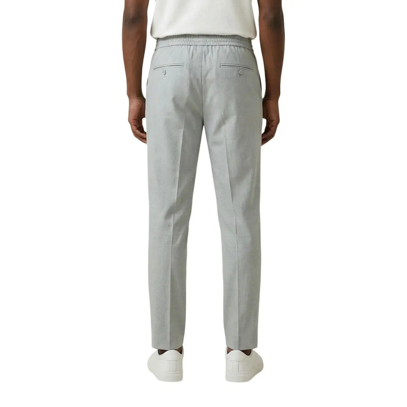 Antony Morato men grey slim-fit polyester viscose trousers with elastic waistband and two back pockets shown from the back side