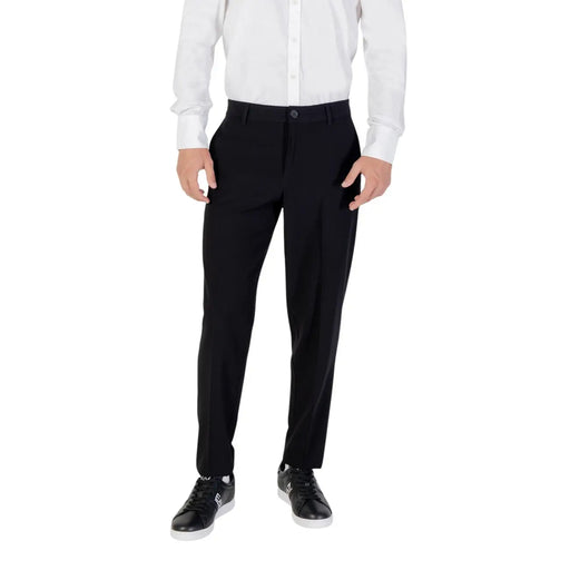 Men’s black trousers with white shirt and black sneakers from Armani Exchange fall winter collection