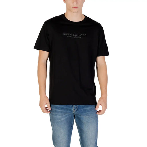 Men’s black short-sleeve crew neck T-shirt paired with light blue jeans from Armani Exchange