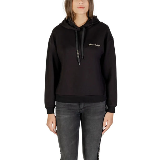 Black long-sleeved hoodie with drawstring and ribbed hem paired with dark grey skinny jeans