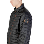 Black quilted puffer jacket with circular patch on sleeve and orange zipper accents for cold weather use