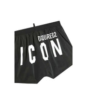 Black dsquared2 swim trunks in black featuring bold white icon lettering and a white drawstring on the front