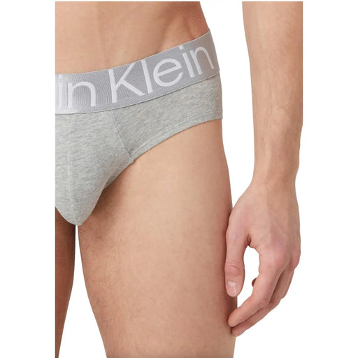 Gray heathered calvin klein men’s briefs with matching elastic waistband featuring white calvin klein logo