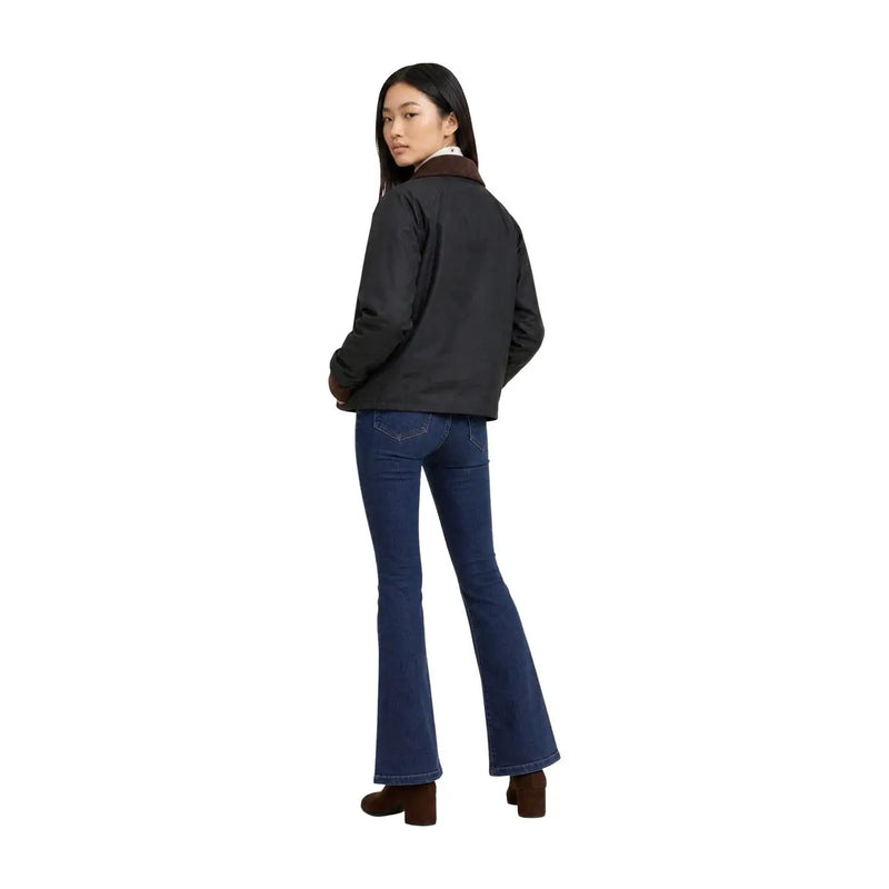 Schwarze Jacke mit braunem Shearling-Kragen kombiniert mit dunkelblauen Schlagjeans für einen stylischen Freizeitlook
