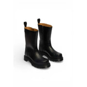 Schwarze Dr. Martens Damen-Ankle-Boots aus Leder mit klobiger Gummisohle und Zuglaschen, von der Rückseite gesehen