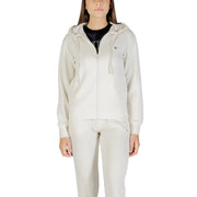 Women wearing beige full-zip hooded tracksuit with black T-shirt, Guess Active Women sweatshirt