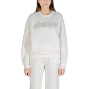 Woman wearing a long-sleeved white sweatshirt with rhinestone GUESS logo on chest