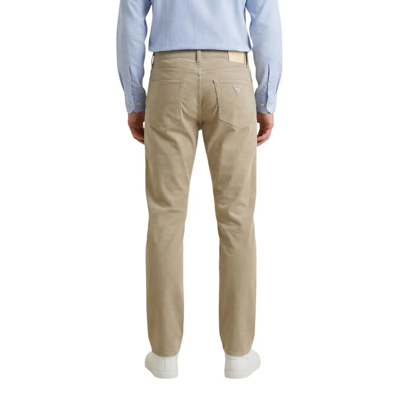 Beige guess men trousers made of cotton blend showing the back side with classic five-pocket design and subtle logo