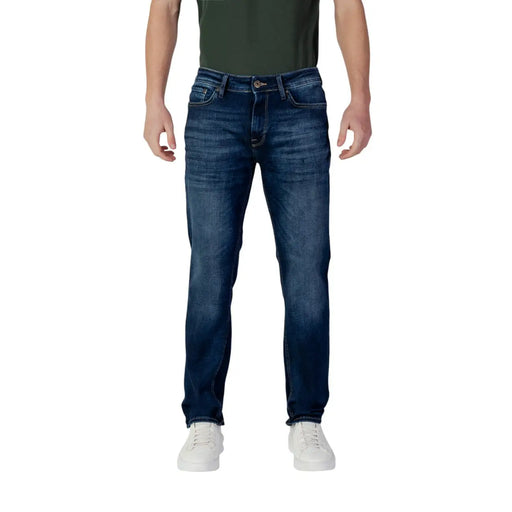 Dark blue denim jeans with a slim fit and light wash design, featuring white stitching.