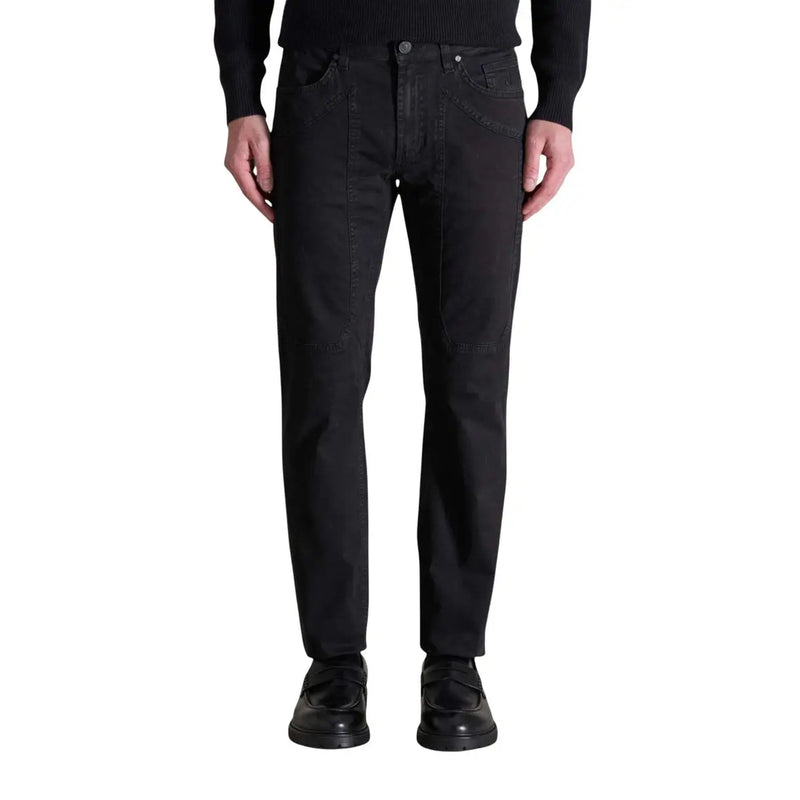 Men’s black denim straight-fit jeans with button-fly closure paired with black loafers