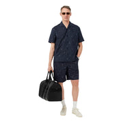 Black textured duffel bag with top handles and front zipper featured with Lacoste Men Shirt branding