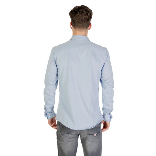 Light blue long sleeved dress shirt with classic collar and buttoned cuffs made of soft breathable fabric