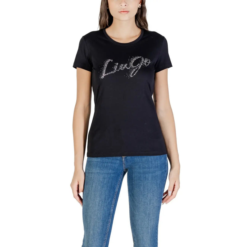 Woman wearing black crew-neck short-sleeve Liu Jo T-shirt with sparkly logo and blue jeans