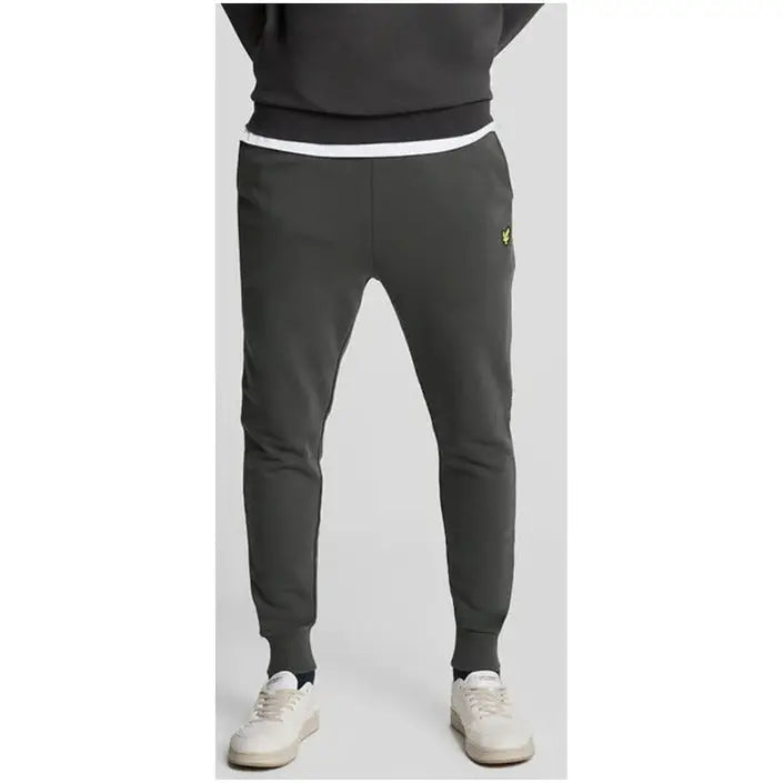 Dark gray Lyle & Scott sweatpants with yellow logo on upper left thigh