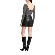 Woman wearing Morgan De Toi Black Striped Long Sleeve Sweater with leather shorts and boots