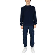 Navy blue long sleeved knit sweater featuring a subtle zippered pocket on the left sleeve for practical use