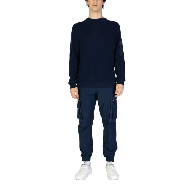 Navy blue long sleeved knit sweater featuring a subtle zippered pocket on the left sleeve for practical use