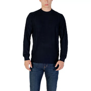 Man wearing navy textured long sleeve sweater and jeans showcasing stylish casual wear