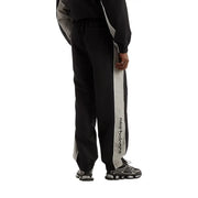 New Balance Herrenhose, schwarze Polyester-Trainingshose für Herbst und Winter mit vertikalem grauen Streifen und schwarzem Logo-Schriftzug