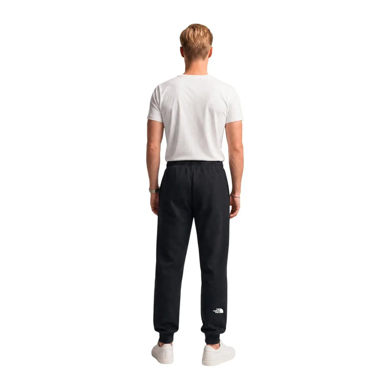 Die schwarzen Baumwollfleecehosen von The North Face für Herren im Jogger-Stil haben ein weißes Logo am linken Bein.