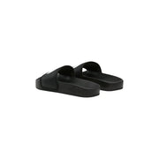 Schwarze Damen-Slipper von The North Face aus Gummi mit minimalistischem Design und dezentem weißen Logo an der Seite.