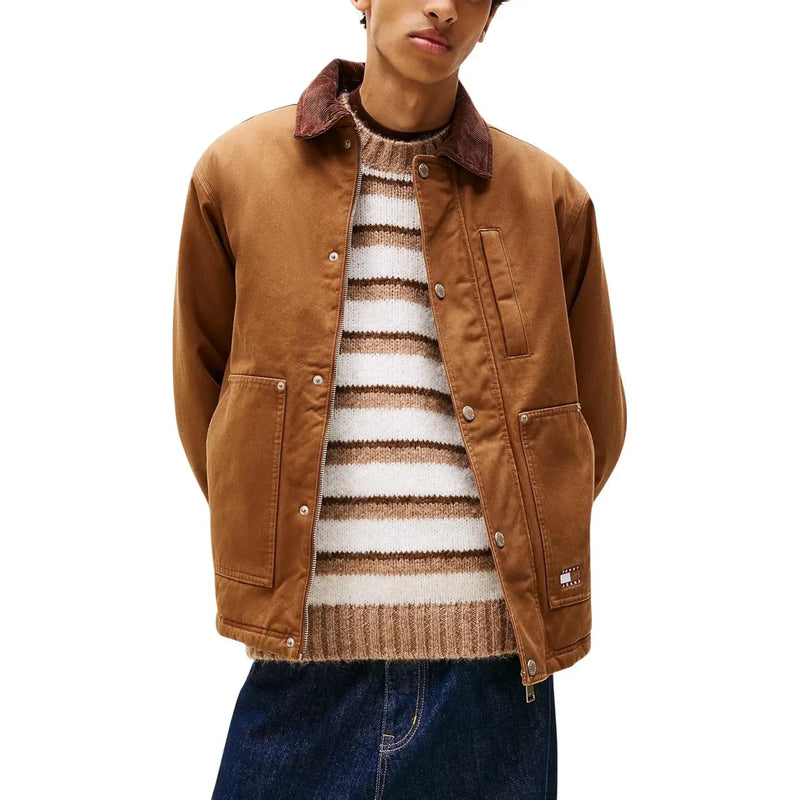 Men’s brown corduroy-collar workwear jacket over striped knit sweater and dark wash jeans