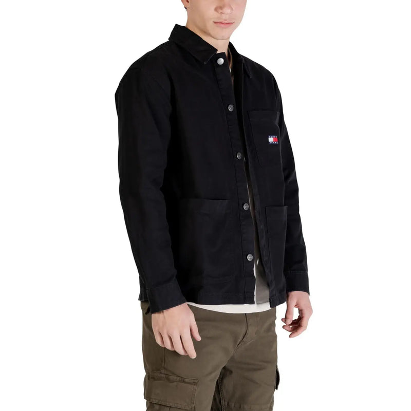 Black tommy hilfiger button-up work jacket with chest pocket and iconic flag logo featured in tommy hilfiger jeans men shirt