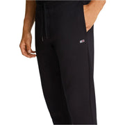 Schwarze, schmal geschnittene Tommy Hilfiger Baumwollfleece-Jogginghose mit Kordelzugbund und Logo-Patch an der Seitennaht.