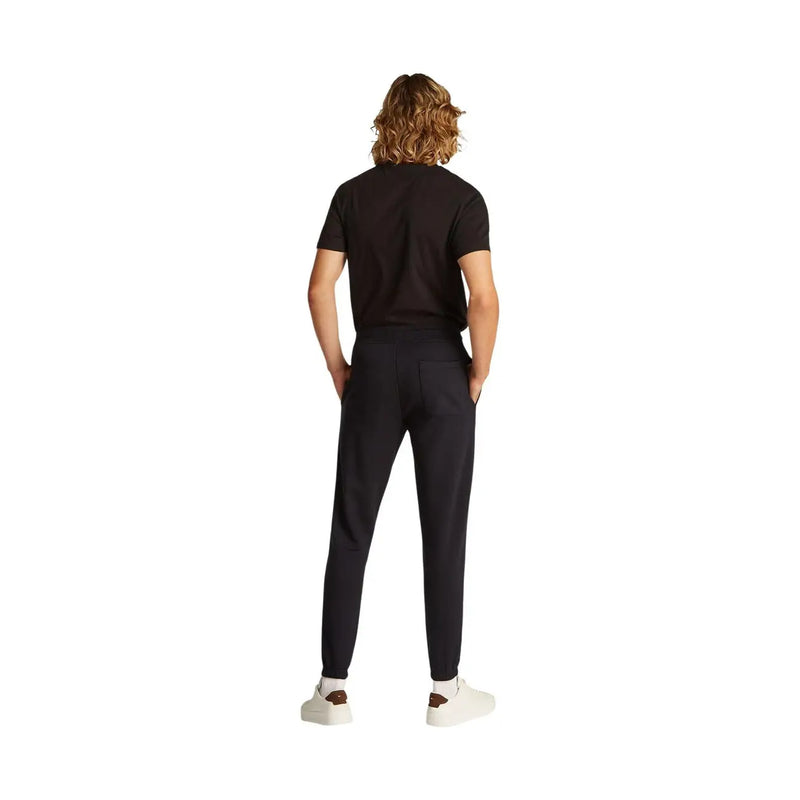 Tommy Hilfiger Schwarze Herren-Jogginghose aus Baumwollfleece mit schmaler Passform und elastischen Bündchen.