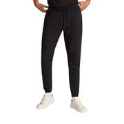 Schwarze, schmal geschnittene Jogginghose aus Baumwollfleece von Tommy Hilfiger mit Kordelzugbund und gerippten Bündchen aus weichem Fleecematerial
