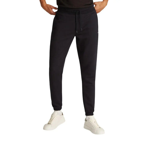 Schwarze, schmal geschnittene Jogginghose aus Baumwollfleece von Tommy Hilfiger mit Kordelzugbund und gerippten Bündchen aus weichem Fleecematerial