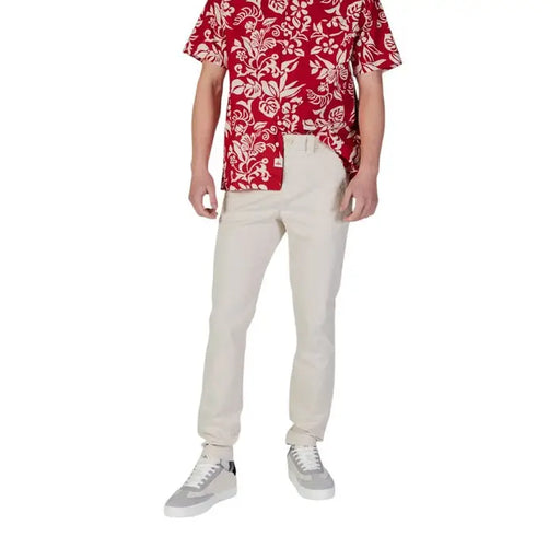 Man wearing floral shirt and chinos with Tommy Hilfiger Men’s Blue Jeans Trousers