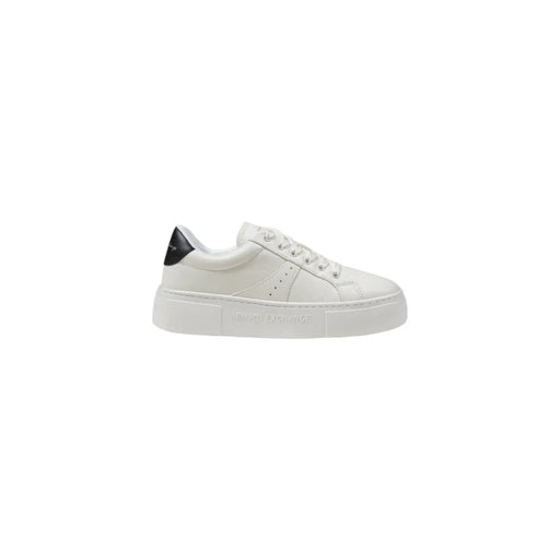 White leather low-top sneaker with black heel accent and embossed branding on the sole shown from the back side