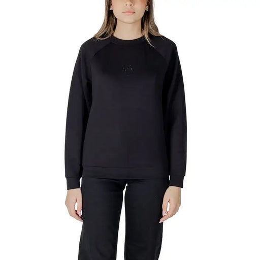 Women’s light blue sweatshirt and black pants set displayed for casual wear