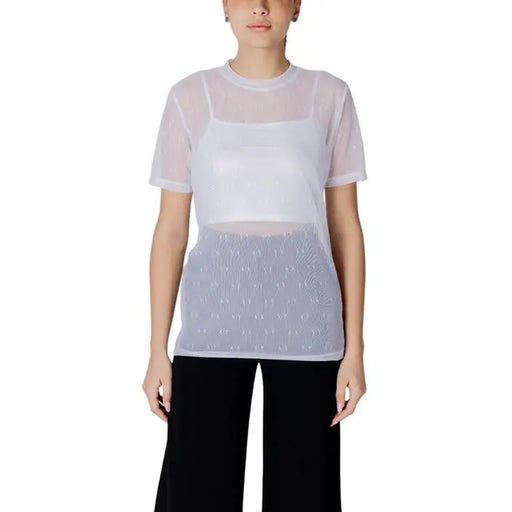 Woman wearing a sheer top with a white tank top underneath in the Women’s Sheer Top with White Tank product image